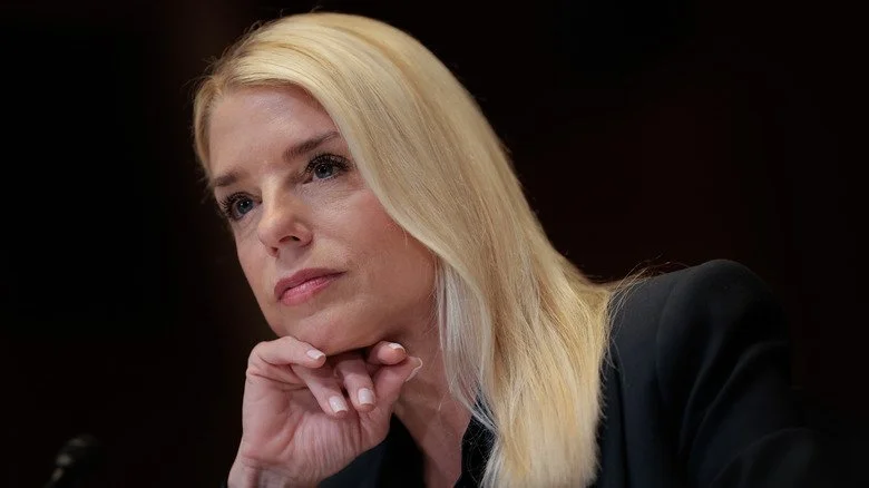 Pam Bondi en arrière-plan noir, écoutant attentivement