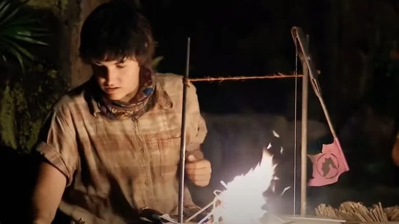Candidat de Survivor allumant un feu