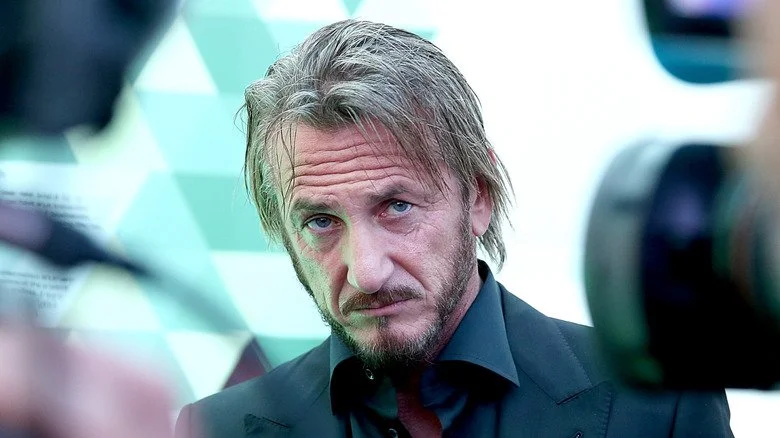 Sean Penn frowning for cameras