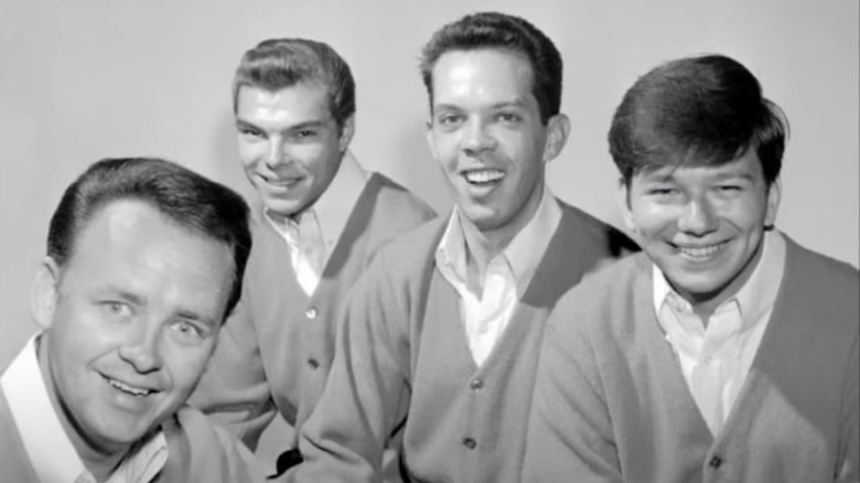 Bob Kuban and the In-Men souriant largement sur une photo publicitaire