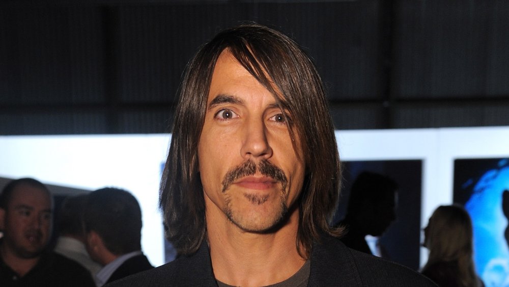 Anthony Kiedis fixant la caméra avec un sourire en coin
