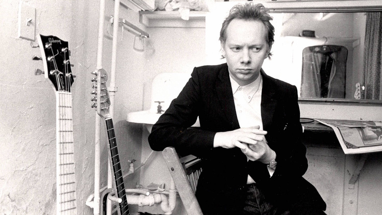Joe Jackson pose pour un portrait aux côtés de guitares