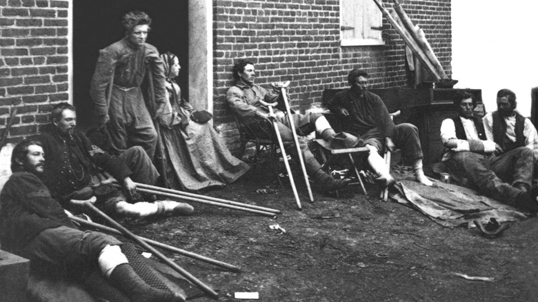 Civil War soldiers on crutches outside