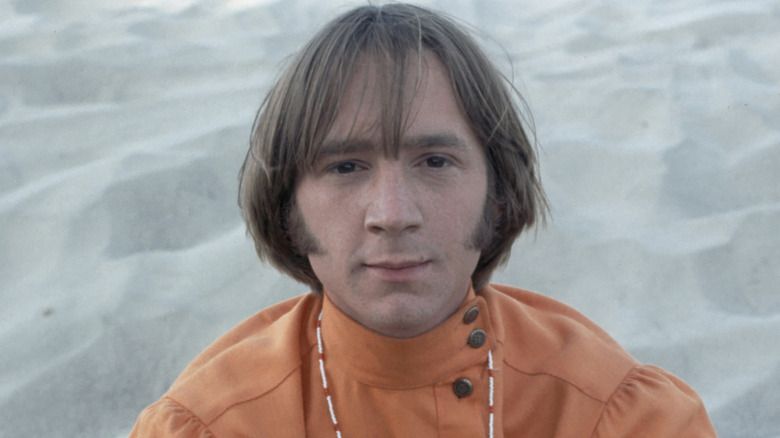 Peter Tork sur une plage en chemise orange