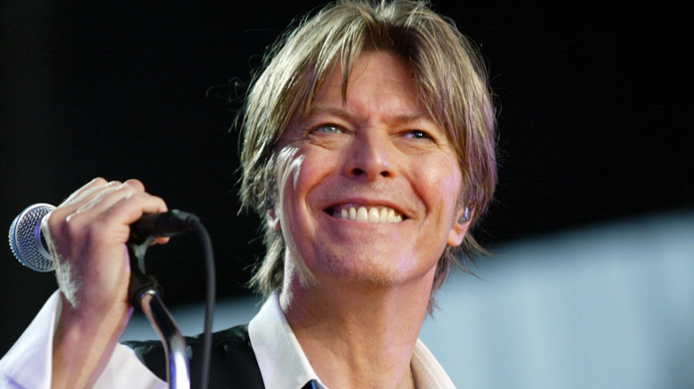David Bowie souriant avec un micro