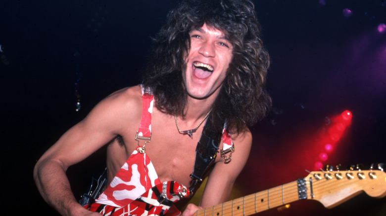 Eddie Van Halen souriant avec sa guitare