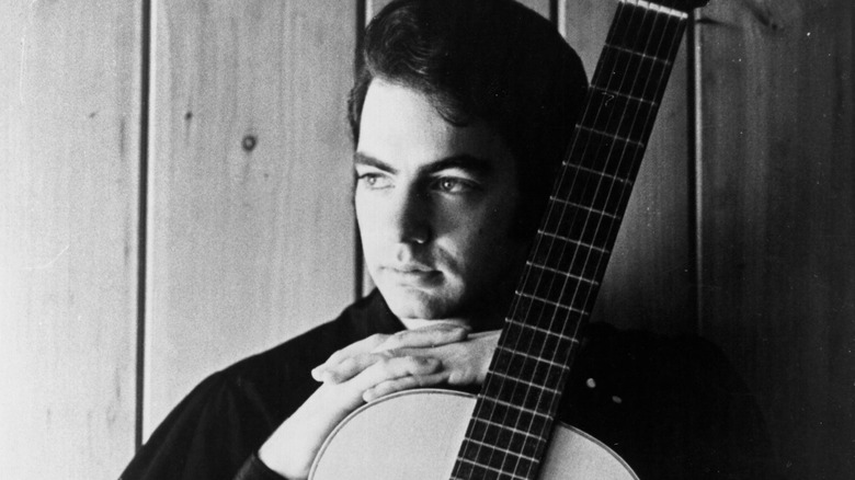Neil Diamond en 1968 posant avec une guitare acoustique